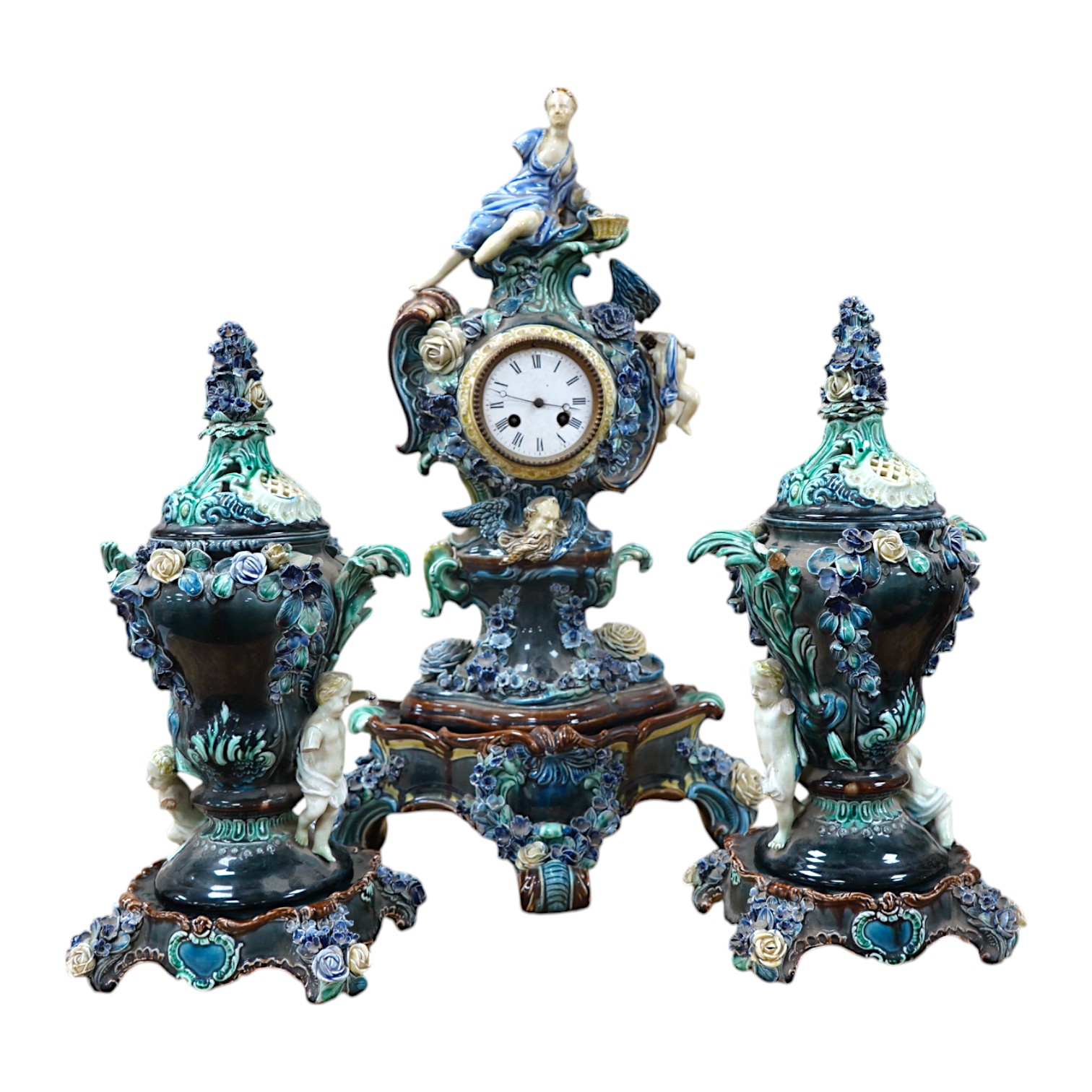 A Rorstrand pottery figural clock garniture with enamel dial and floral encrusted decoration, largest 57cm high. Condition - poor